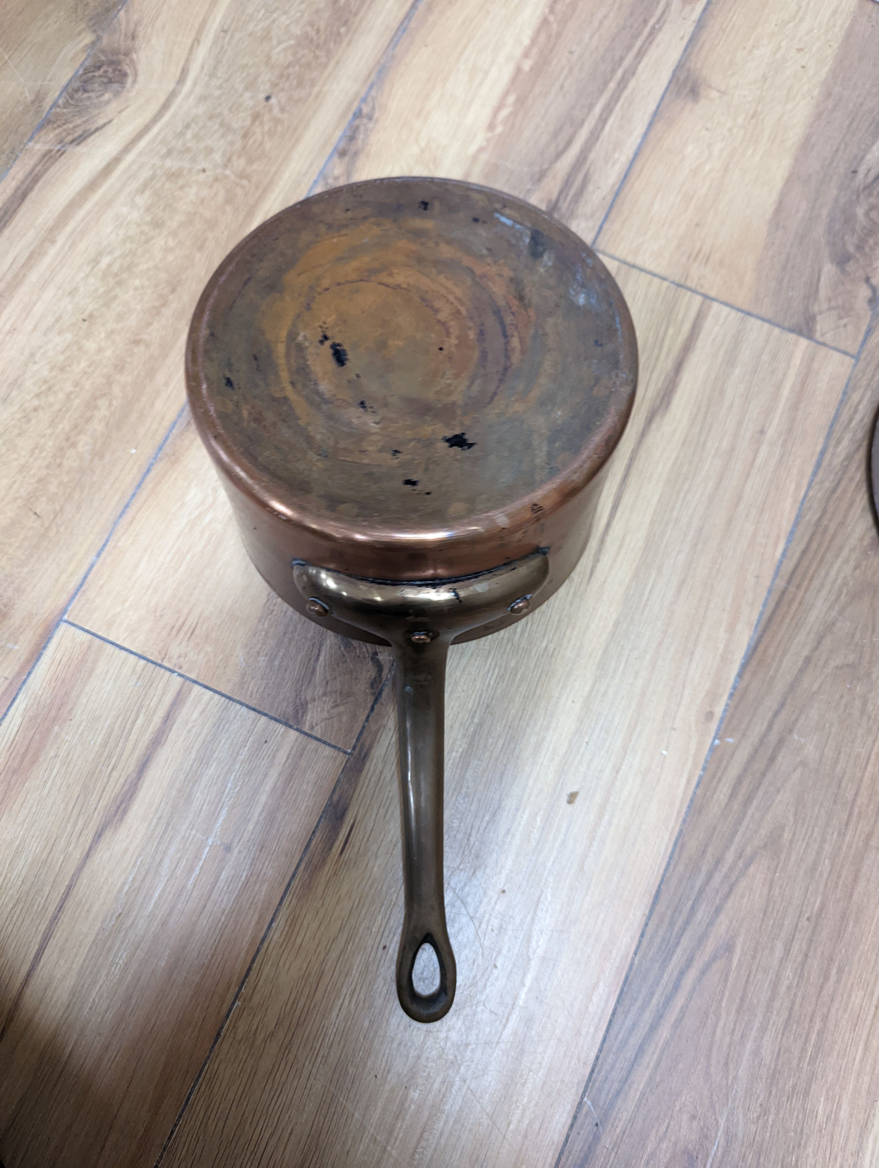 A group of three Jaeggi & Sons copper saucepans